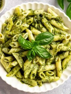 Overhead shot of creamy pesto pasta in a bowl.