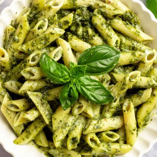 Overhead shot of creamy pesto pasta in a bowl.