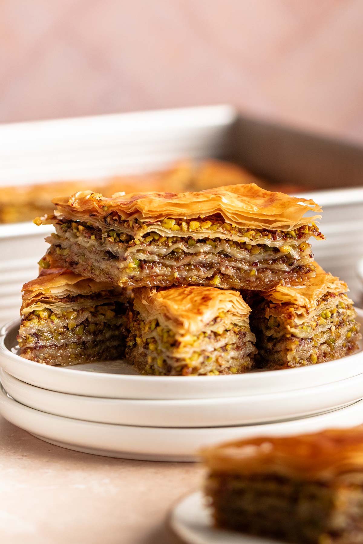 Stack of baklava on a white plate.