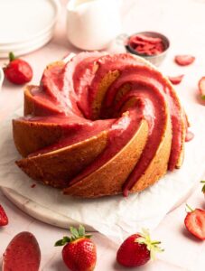 Sliced strawberry bundt cake on a cake platter.