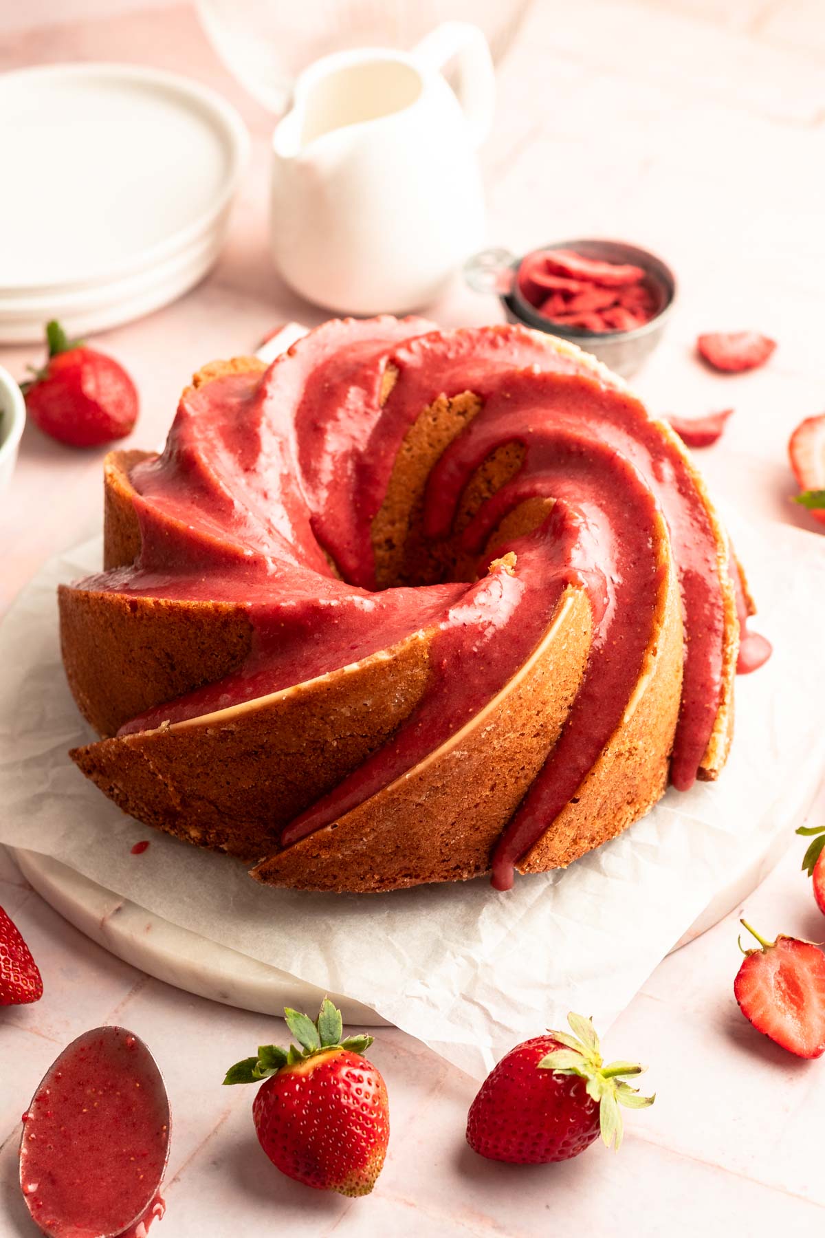 Sliced strawberry bundt cake on a cake platter.