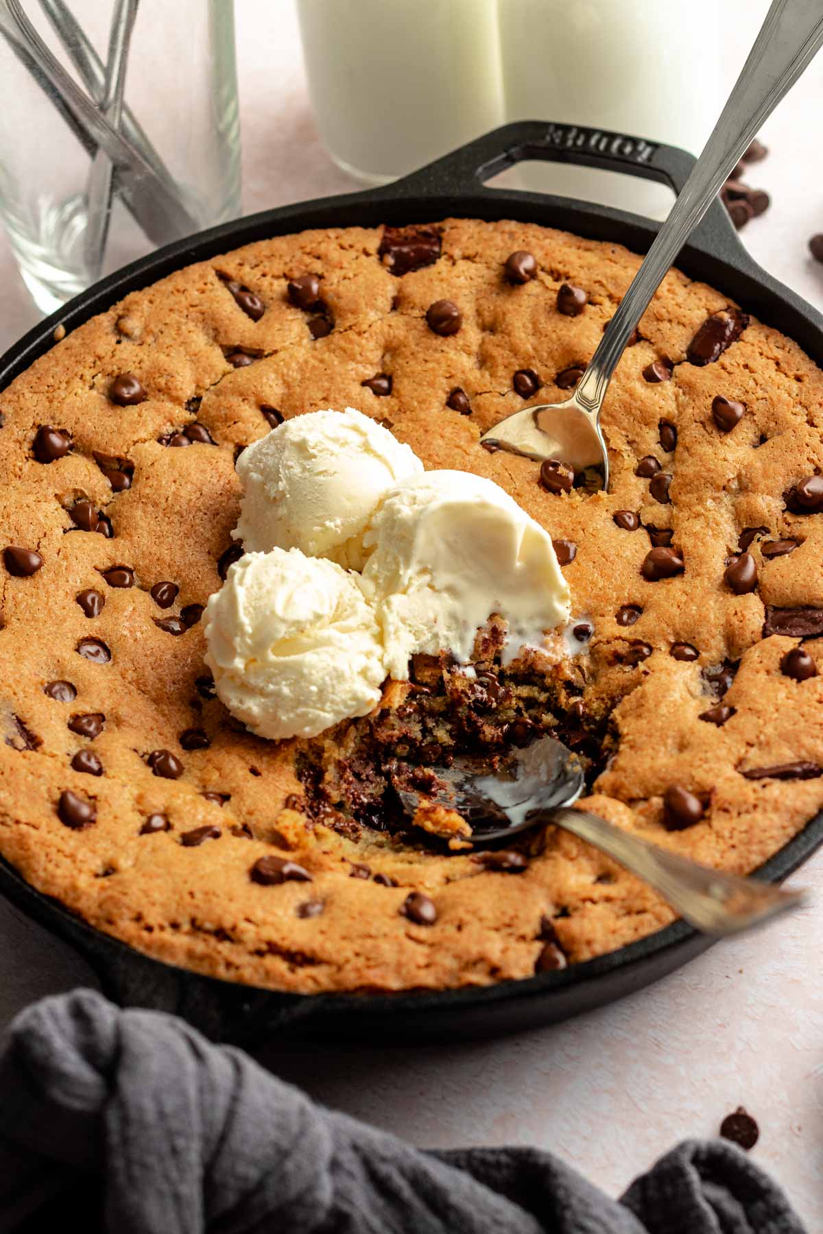 Two spoons scooping up skillet cookie.