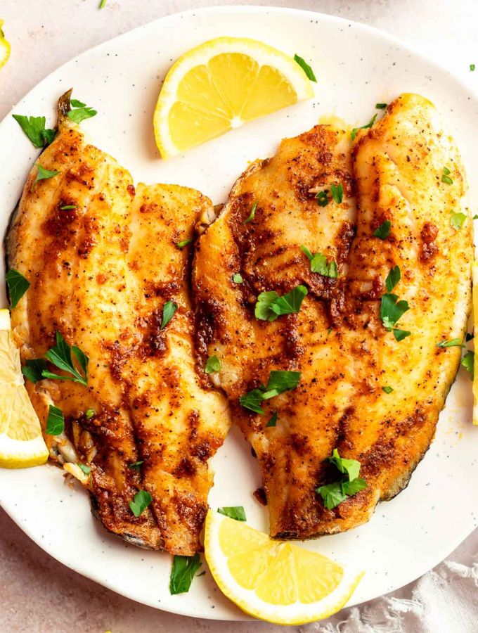 Top of air fryer tilapia on a white plate.