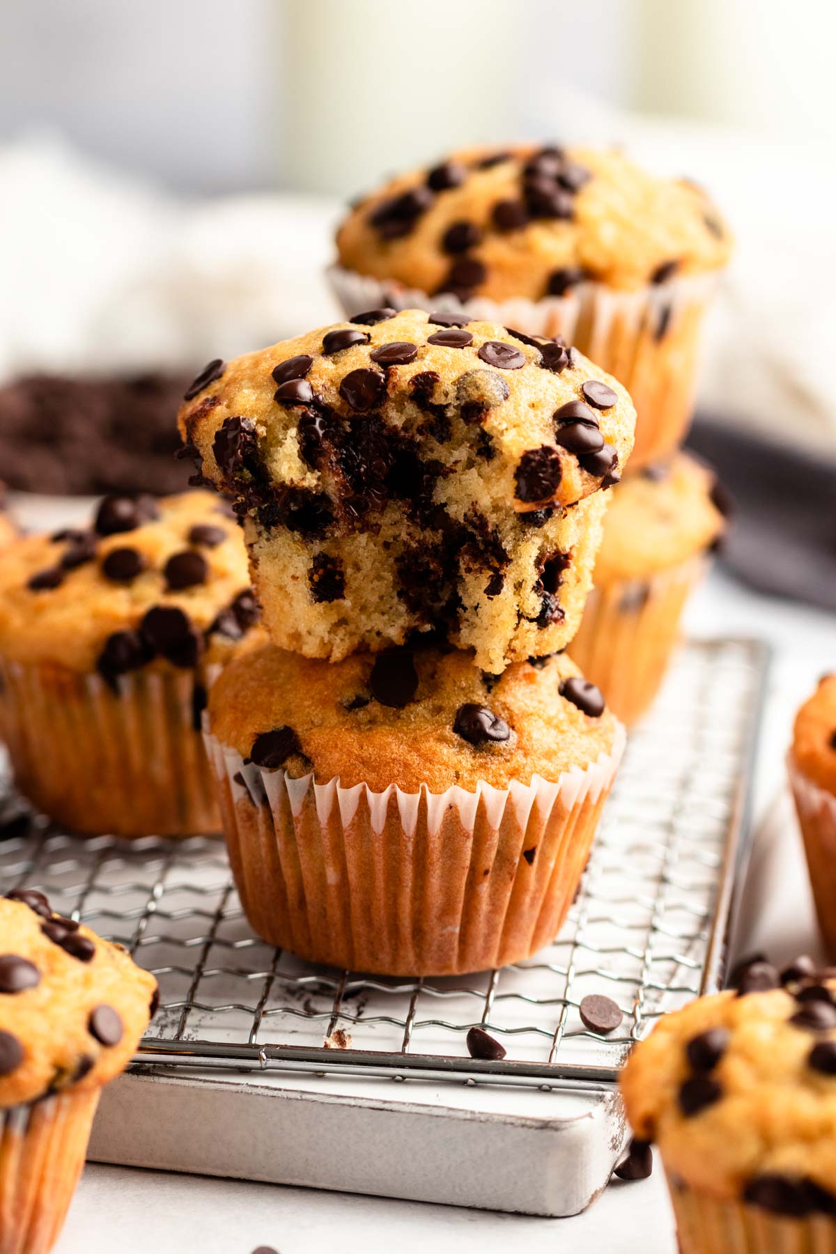 Bite missing from bakery style chocolate chip muffins.