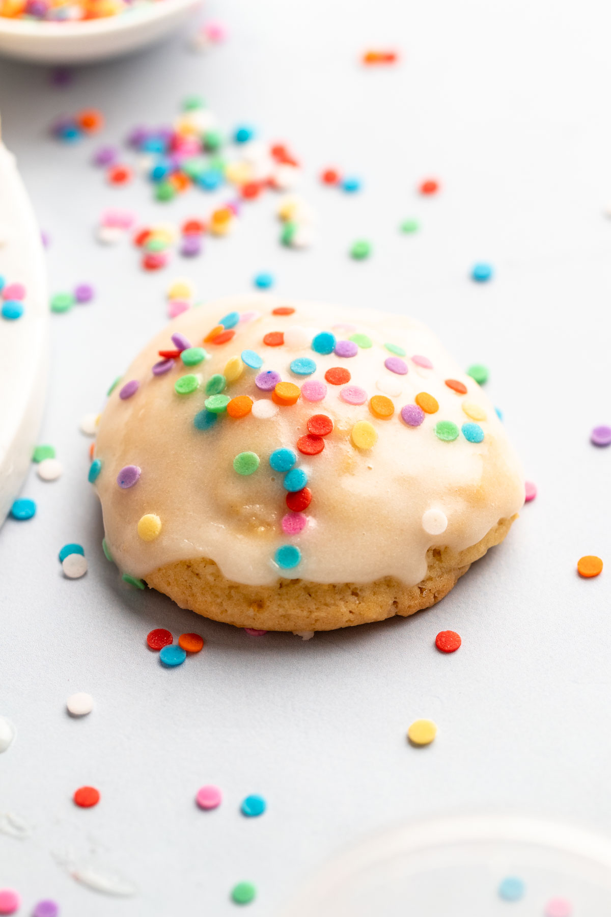 Single cookie with glaze and sprinkles.