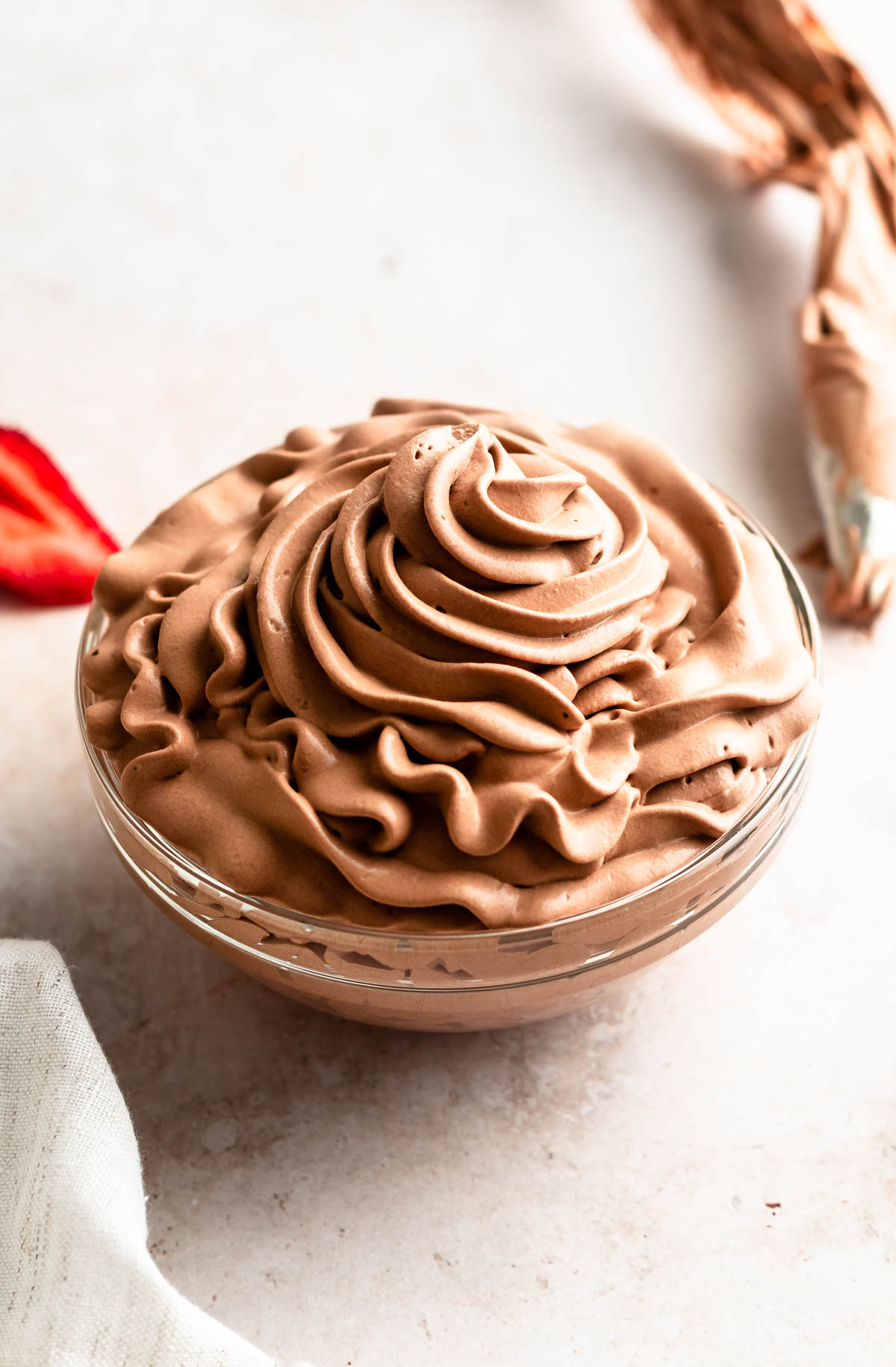 A bowl with chocolate whipped cream frosting.