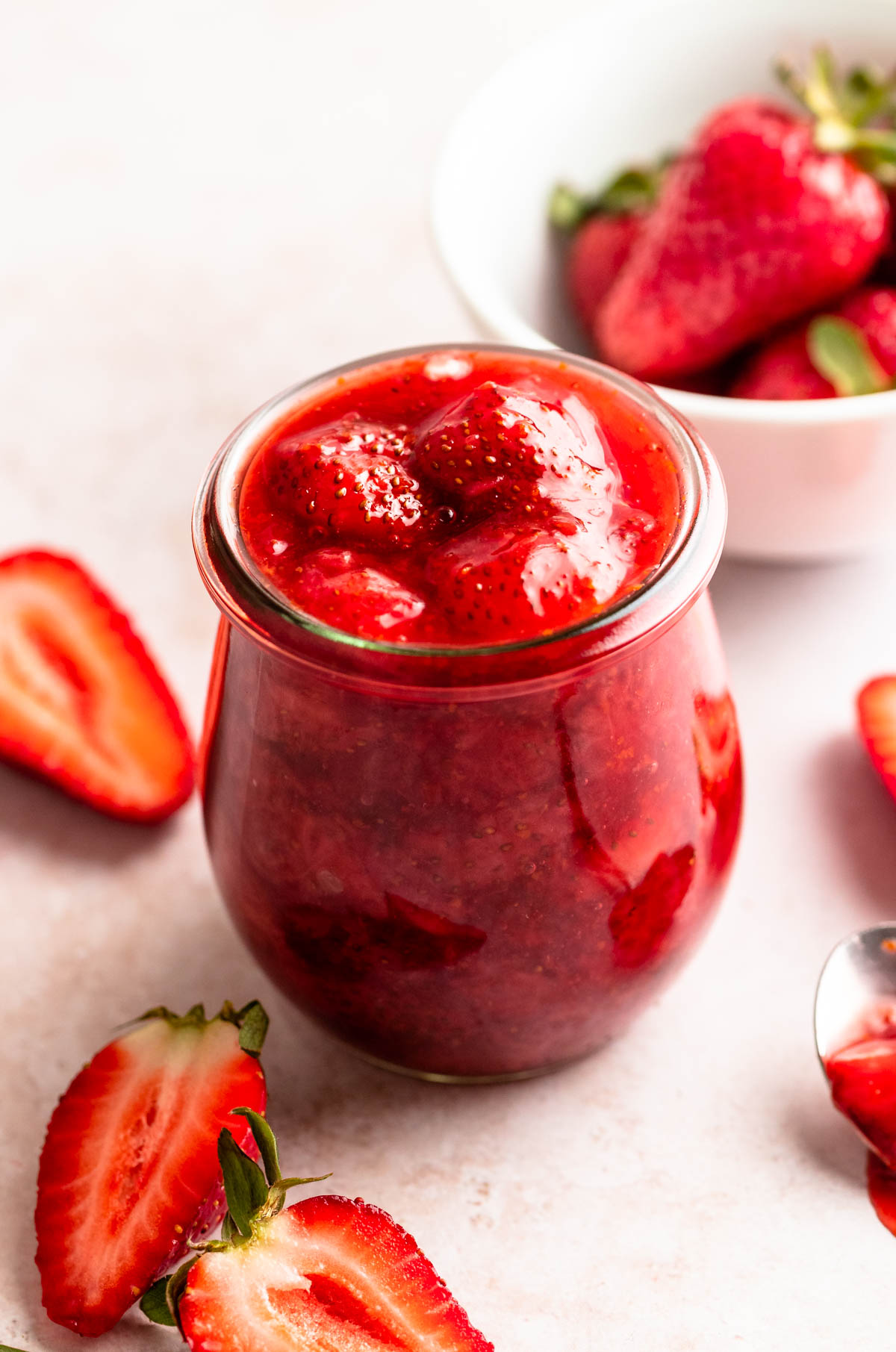 Close up of a mason jar filled with strawberry compote.