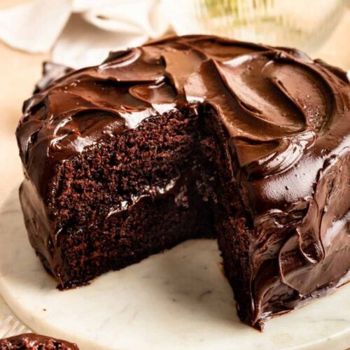 Matildas chocolate cake sliced open on a cake stand.