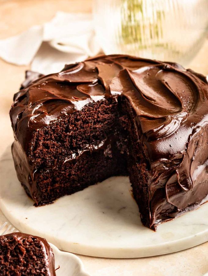 Matildas chocolate cake sliced open on a cake stand.