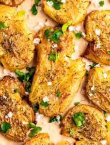 Top of smashed fingerling potatoes on a parchment paper.