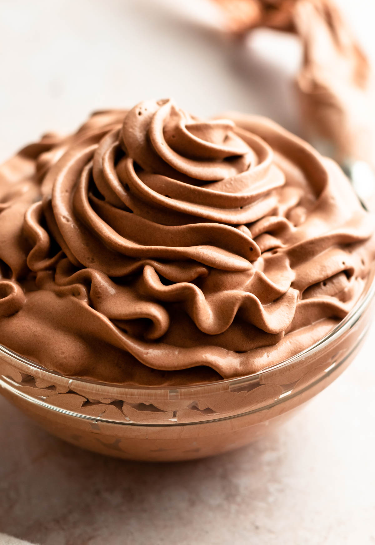 Close up shot of chocolate cream in a glass bowl.