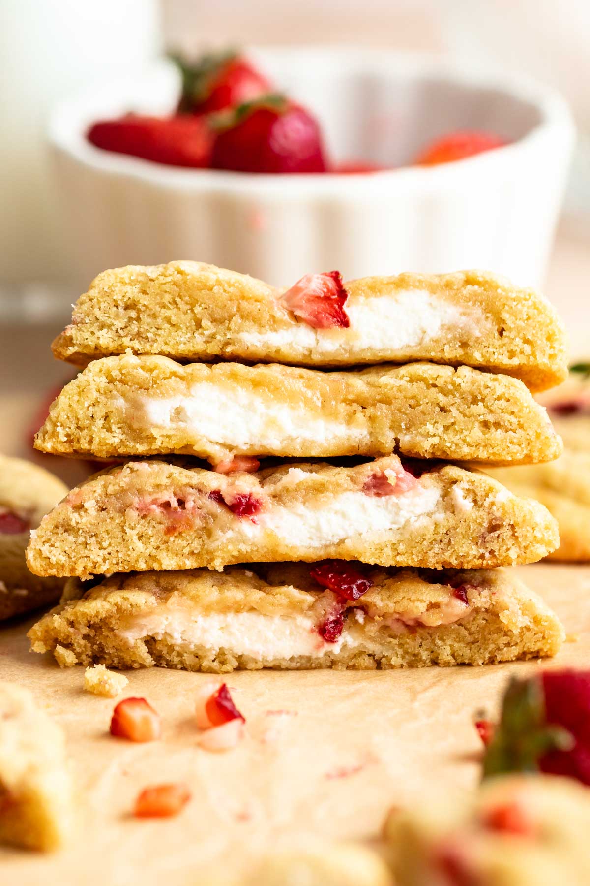 Stack of strawberry cheesecake cookies cut in half.
