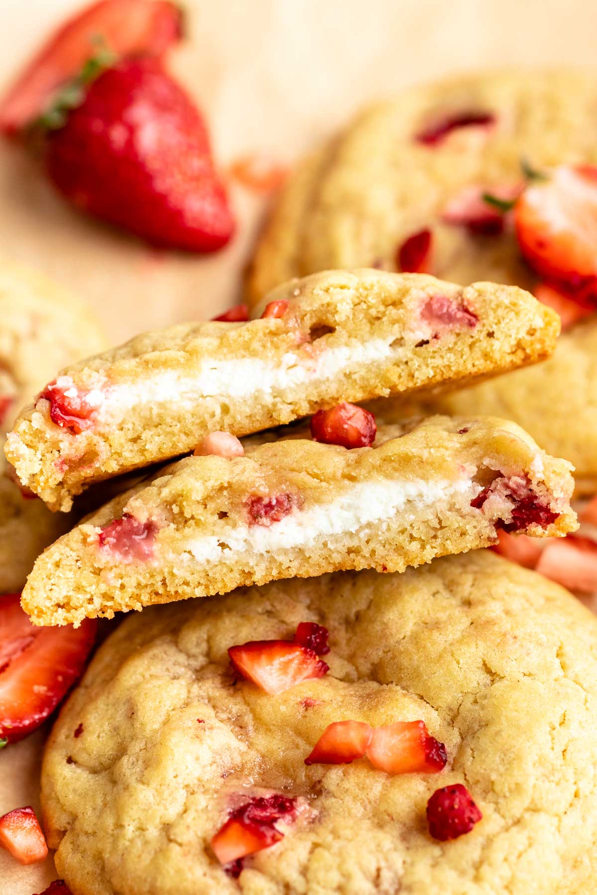 Cream cheese strawberry cookies cut in half.