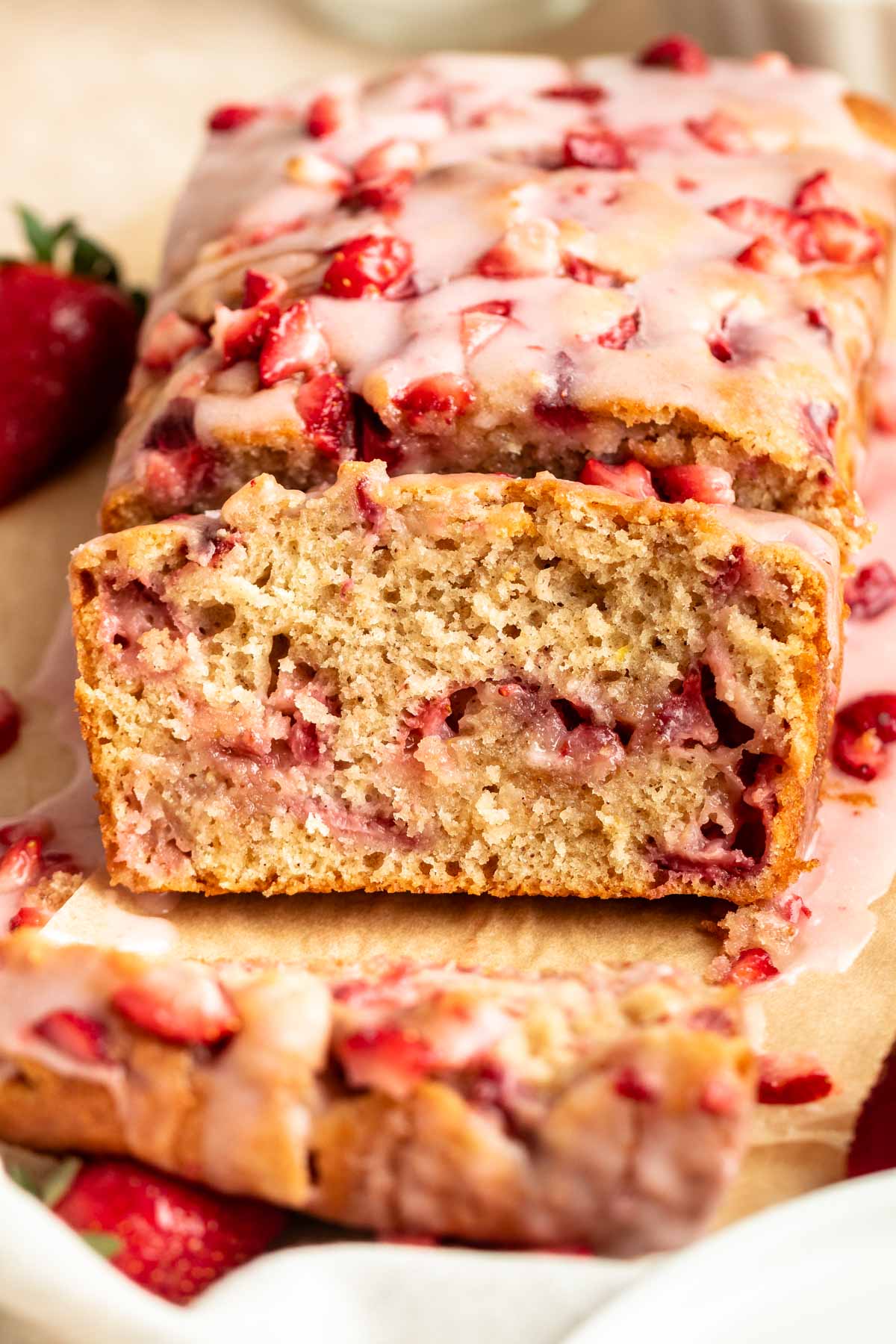 Sliced strawberry bread on a parchment paper.