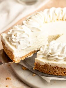 Slice of 3 ingredient no bake cheesecake pulled away from the cheesecake.