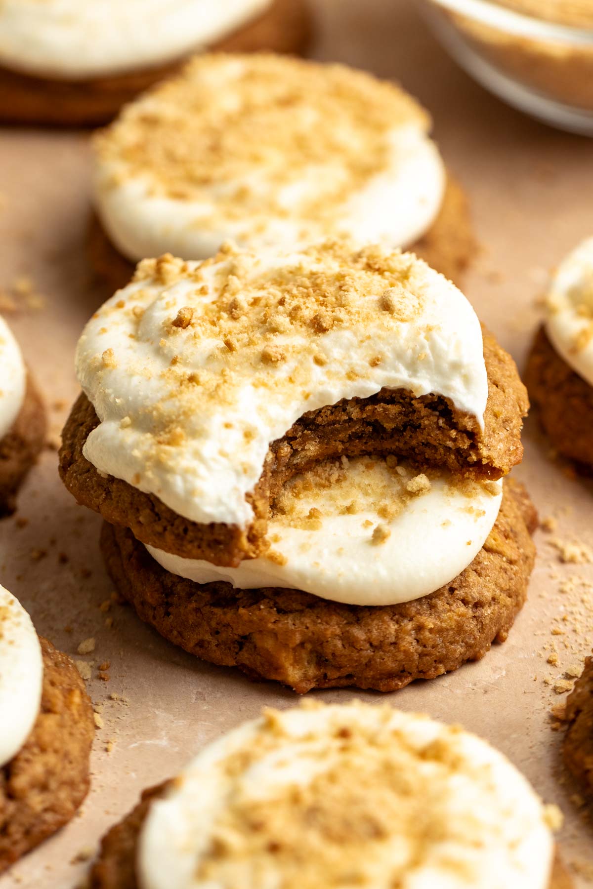 Stack of two cheesecake cookies with the top one missing a bite.