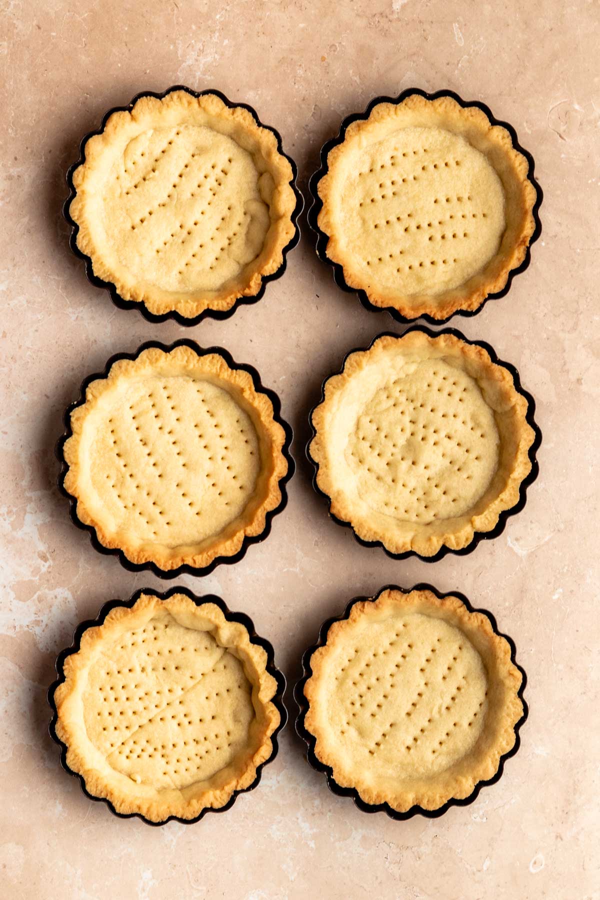 Top of mini tart shells in their pans.