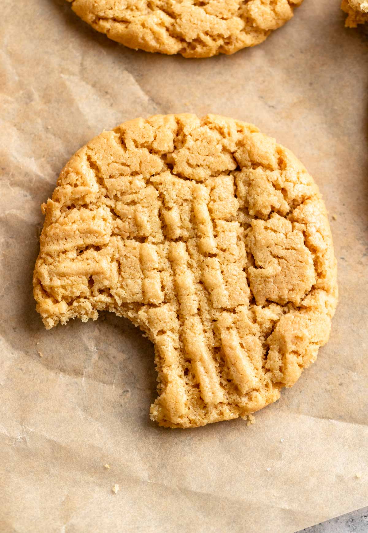 Peanut butter cookie with a bite missing.