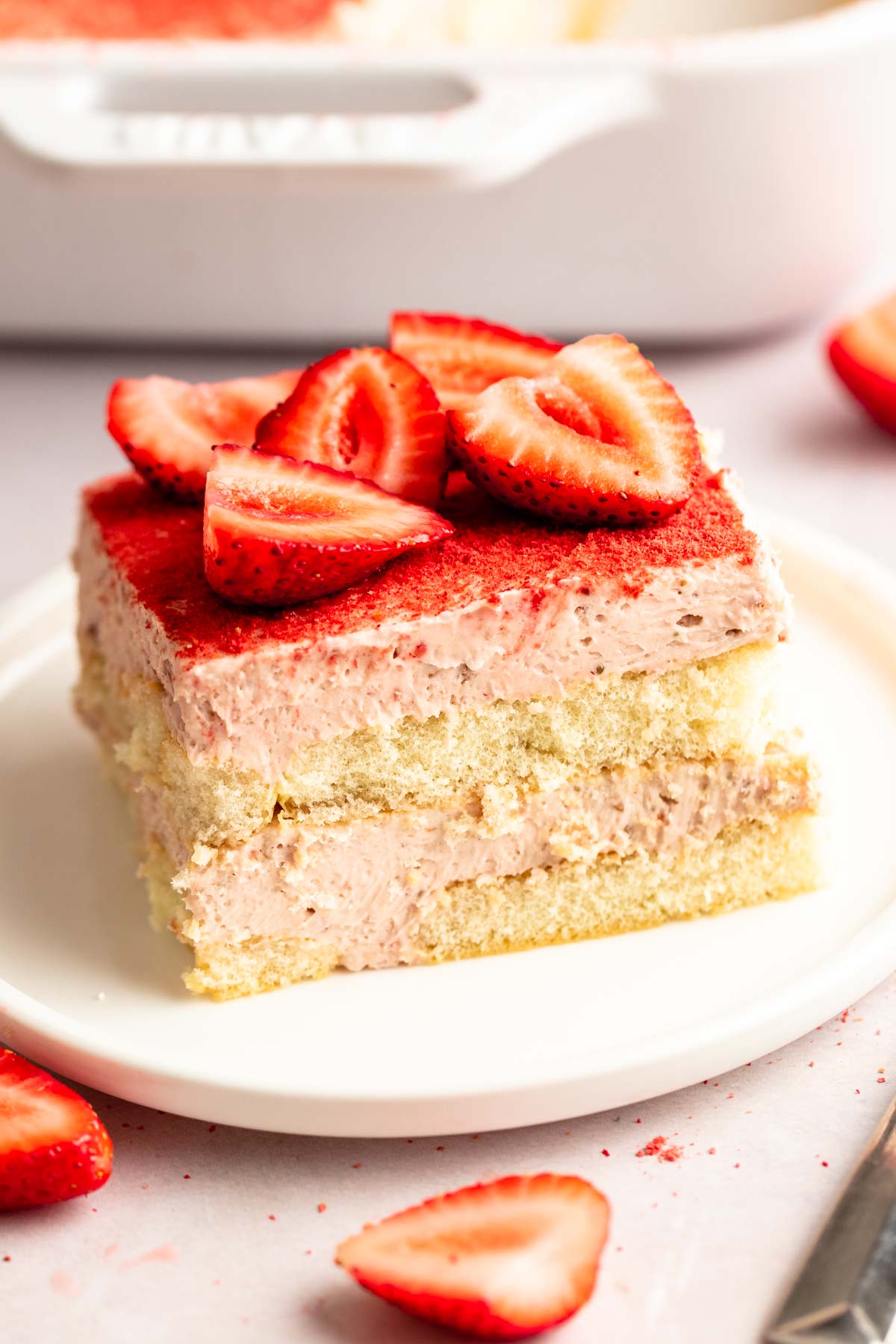 Slice of strawberry tiramisu on a white plate.