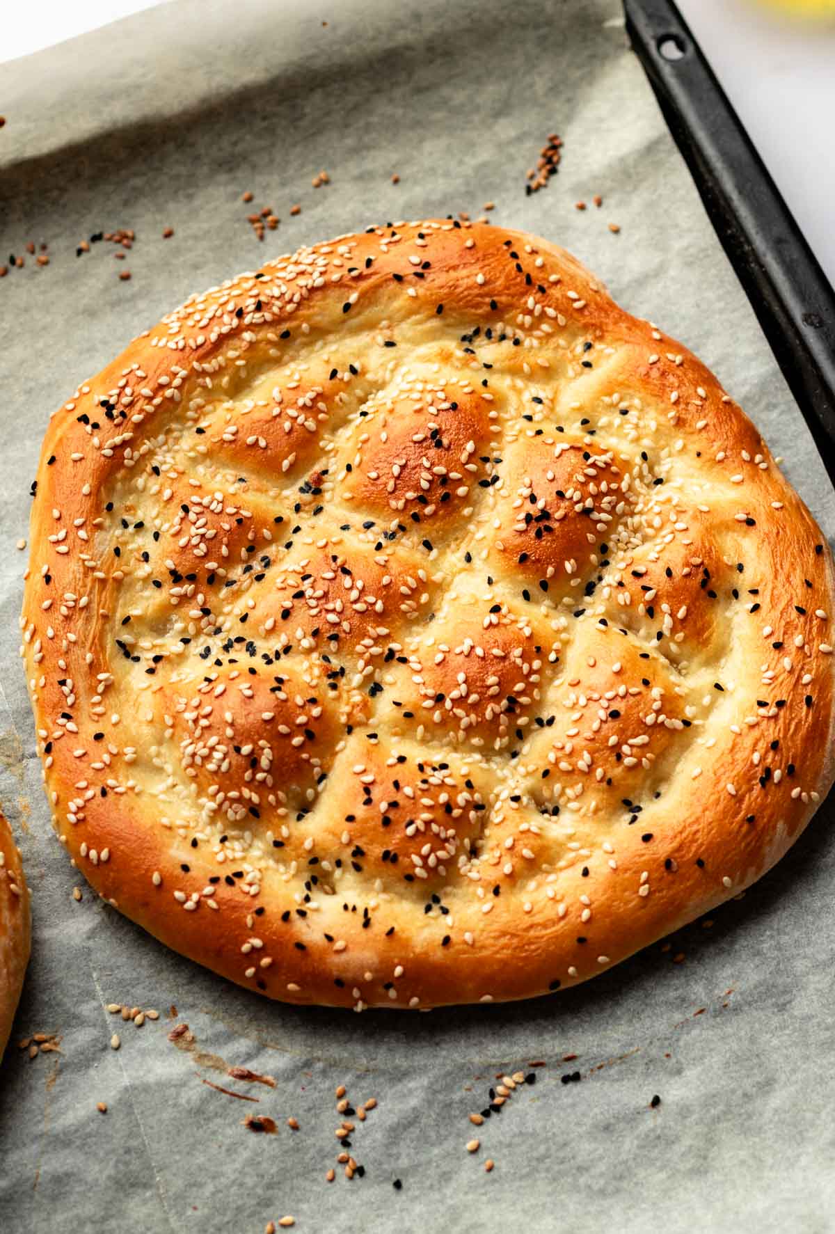 Turkish pide bread on a baking sheet.