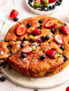 Close up of berry cake on a cake stand.