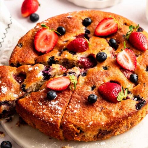 Close up of berry cake on a cake stand.