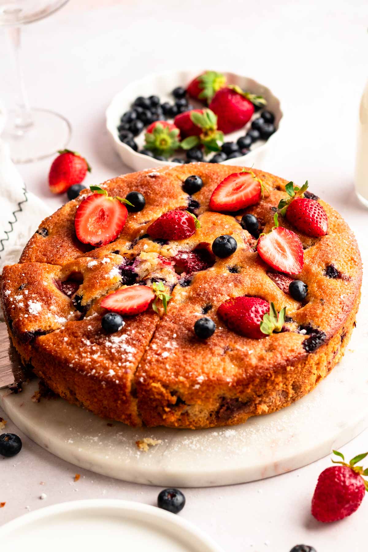 Close up of berry cake on a cake stand.