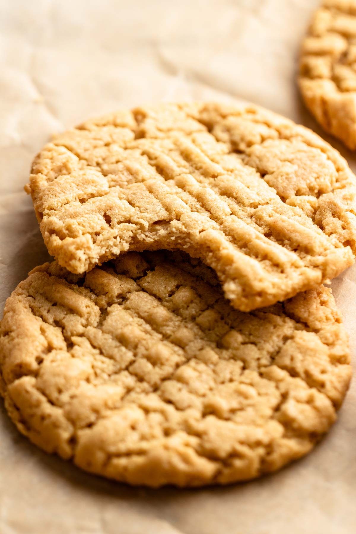 4 ingredient peanut butter cookies with the top one missing a bite.