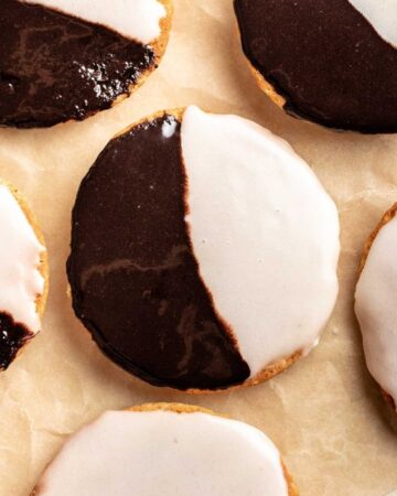 Top of half moon cookies on a parchment paper.