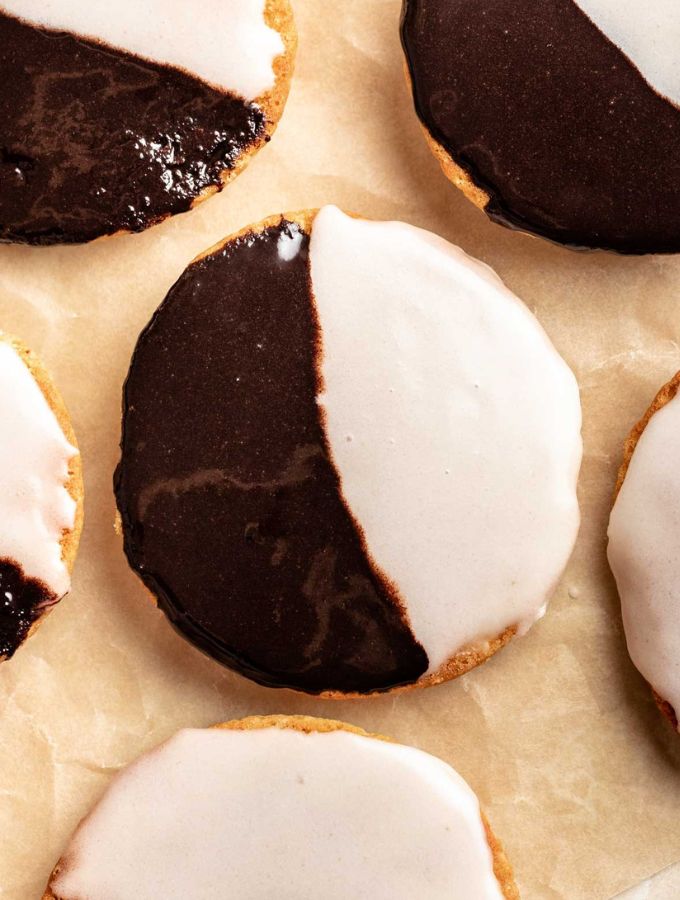 Top of half moon cookies on a parchment paper.