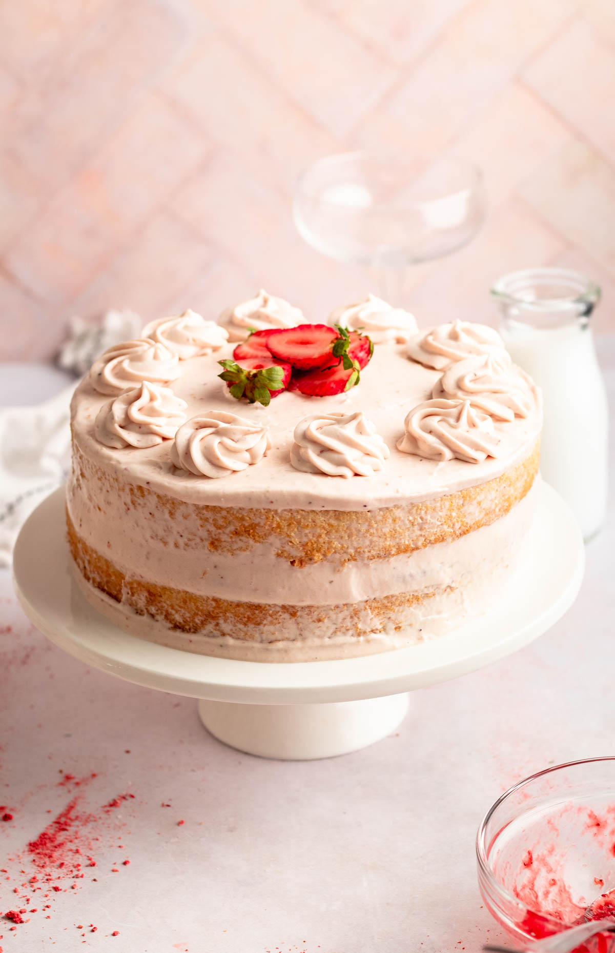 Vanilla cake with strawberry filling on a cake platter.