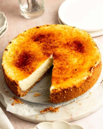 Slice missing from a creme brulee cheesecake.