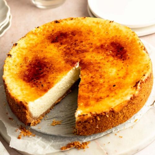 Slice missing from a creme brulee cheesecake.