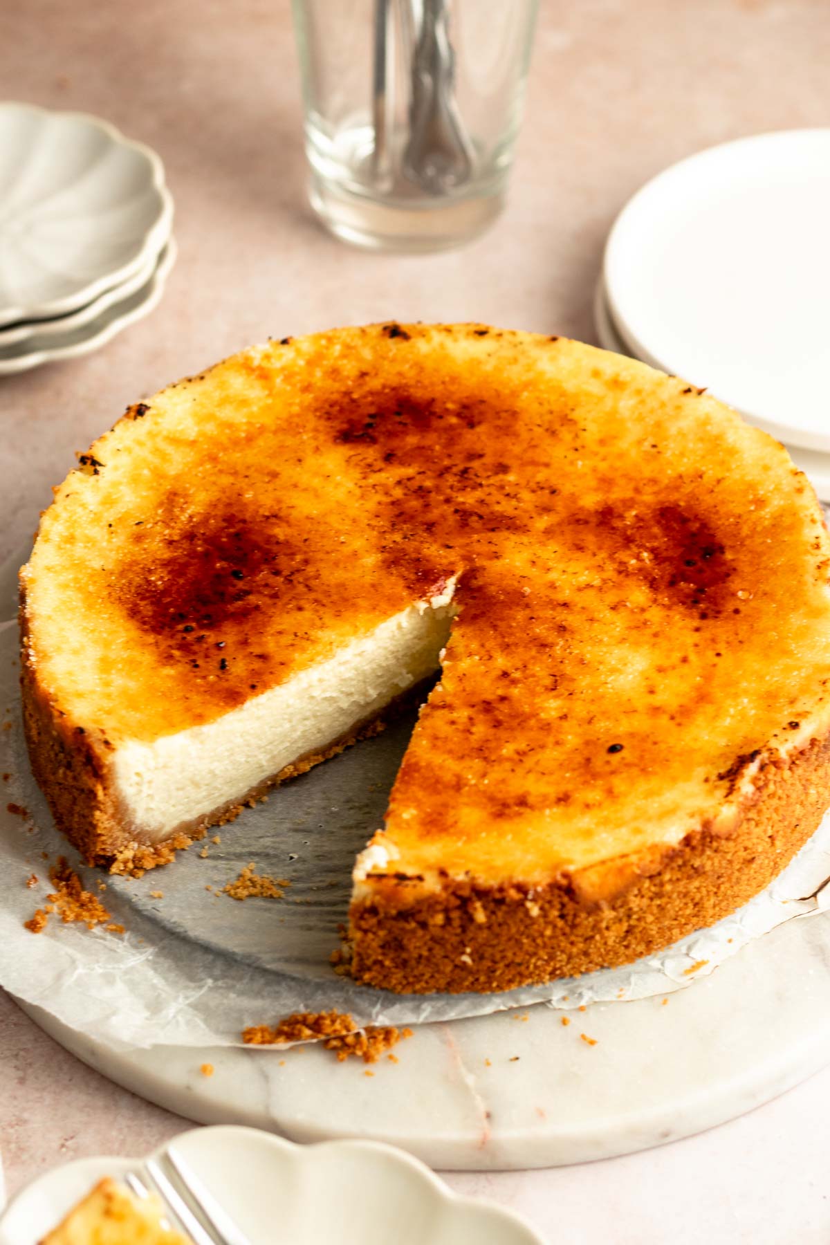 Slice missing from a creme brulee cheesecake.