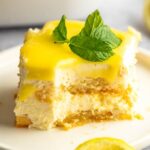 Bite missing from a slice of lemon tiramisu.