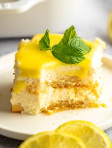 Bite missing from a slice of lemon tiramisu.