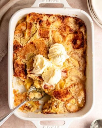 Overhead shot of 3 ingredient peach cobbler with ice cream.