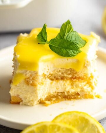 Bite missing from a slice of lemon tiramisu.