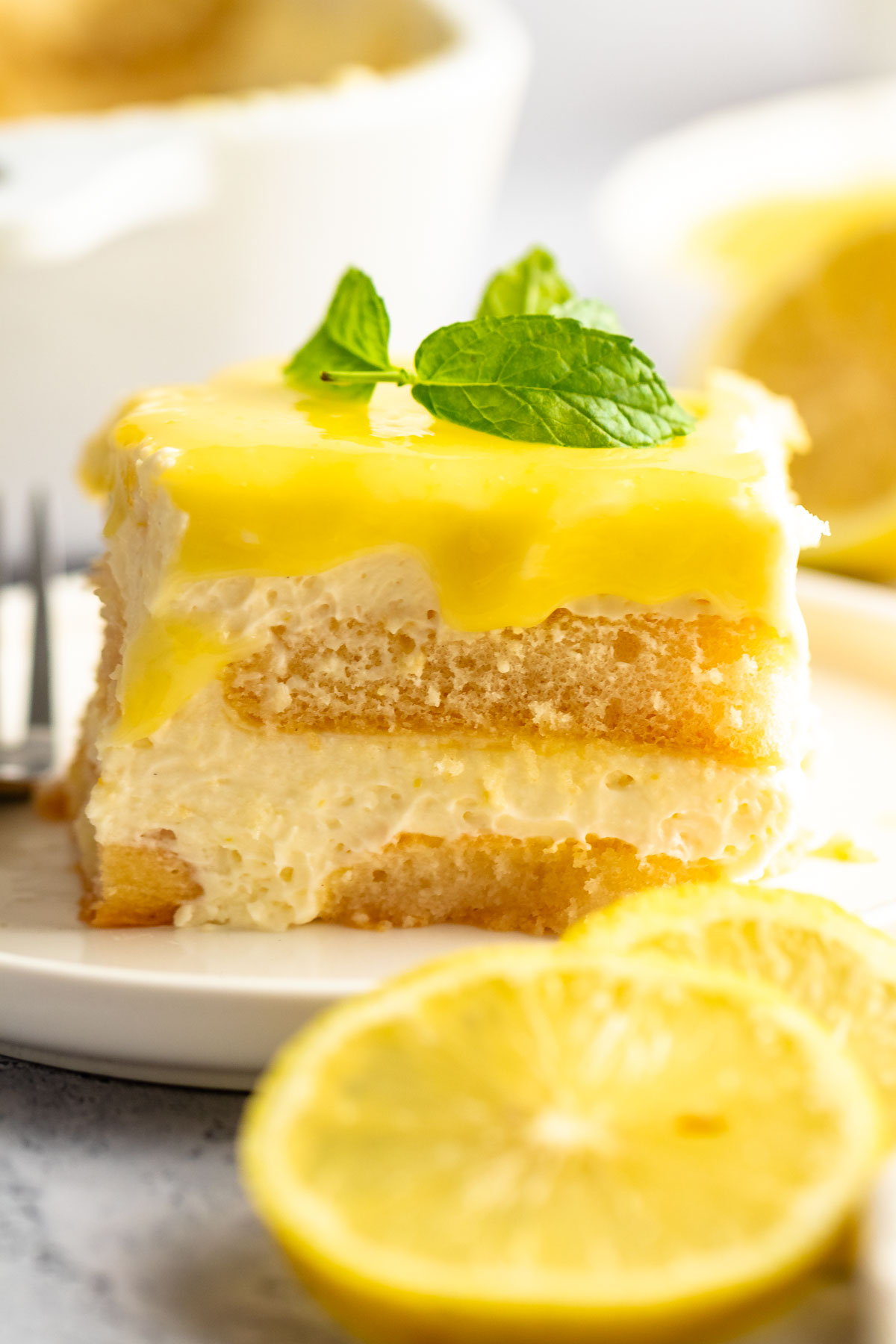 Slice of lemon tiramisu on a white plate.