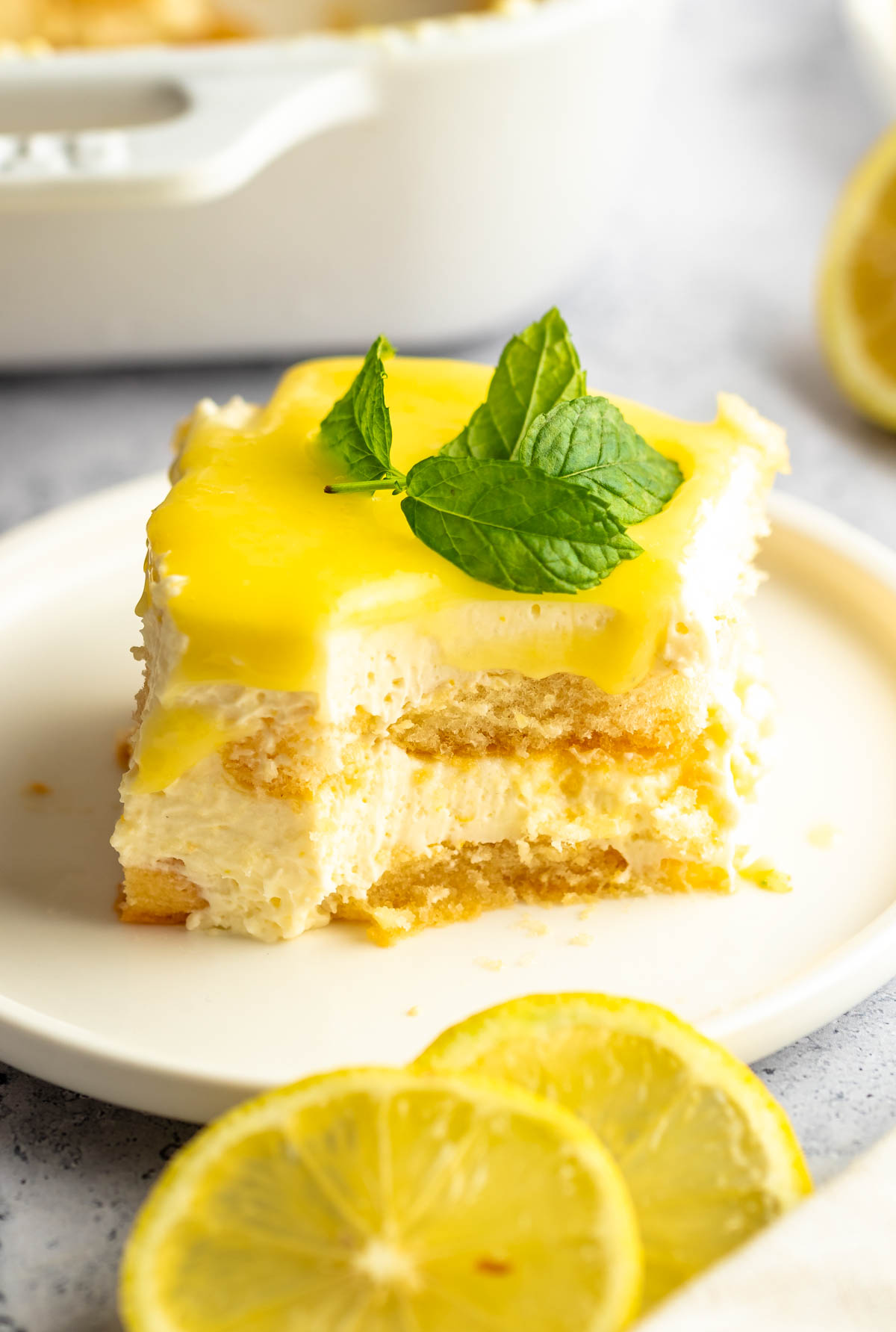 Bite missing from a slice of lemon tiramisu.