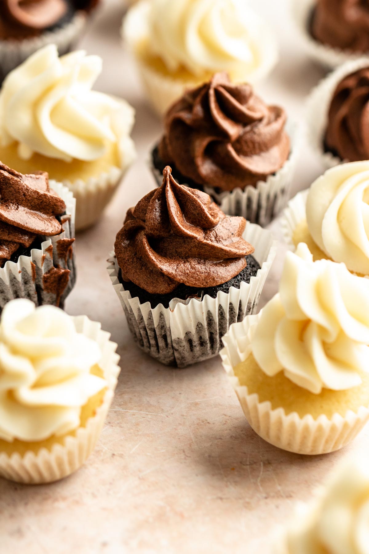 Mini cupcakes with buttercream frosting on top.