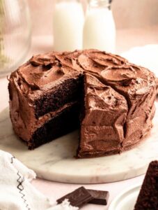 Chocolate coffee cake with a slice missing.
