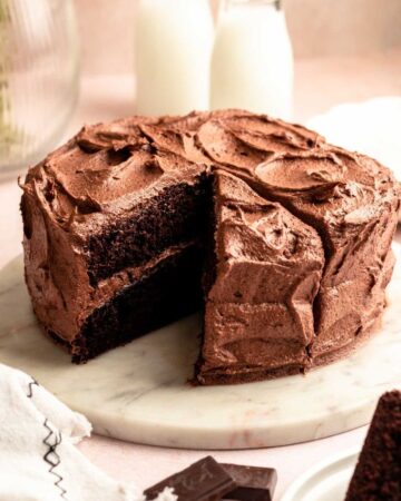 Chocolate coffee cake with a slice missing.