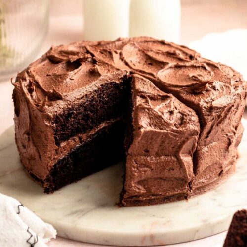 Chocolate coffee cake with a slice missing.
