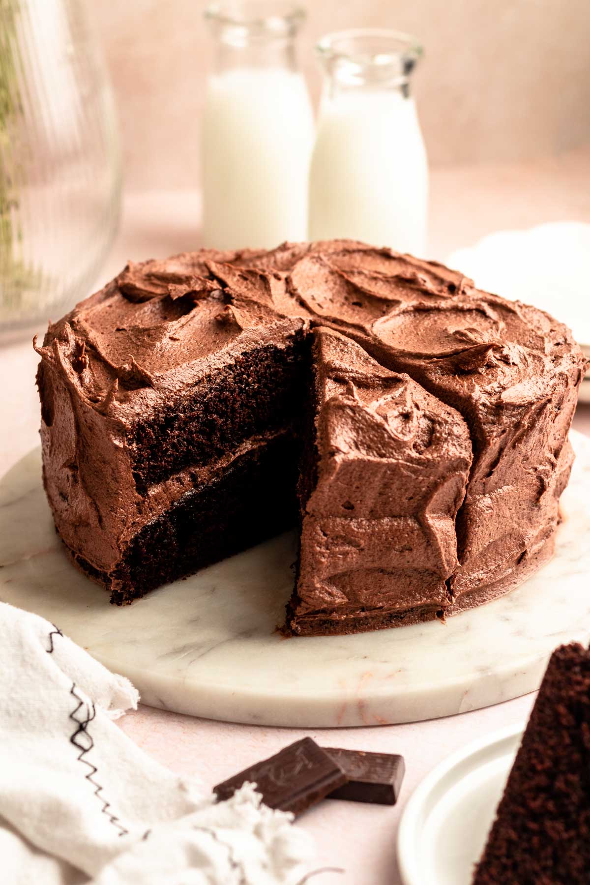 Chocolate coffee cake with a slice missing.