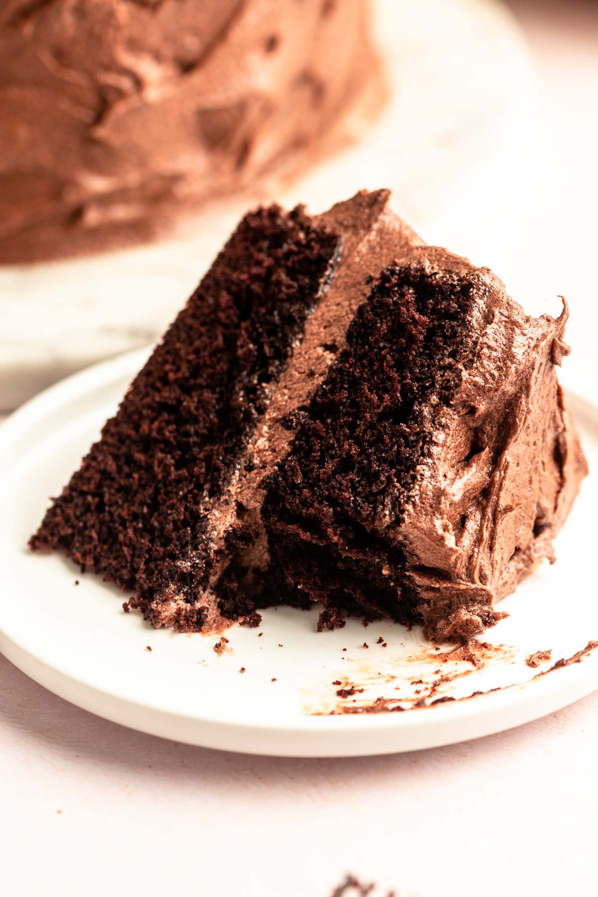 Slice of chocolate and coffee cake on a white plate.