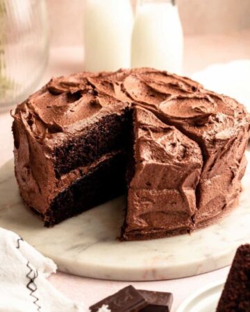 Chocolate coffee cake with a slice missing.