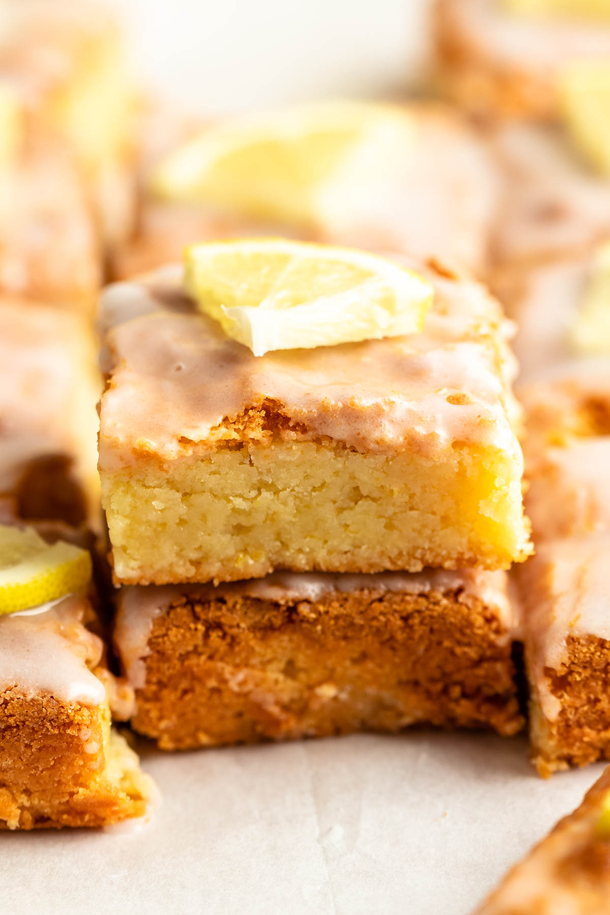 Stack of two pieces of lemon brownies.