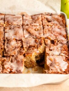 Sliced cinnamon apple cake with a slice missing.
