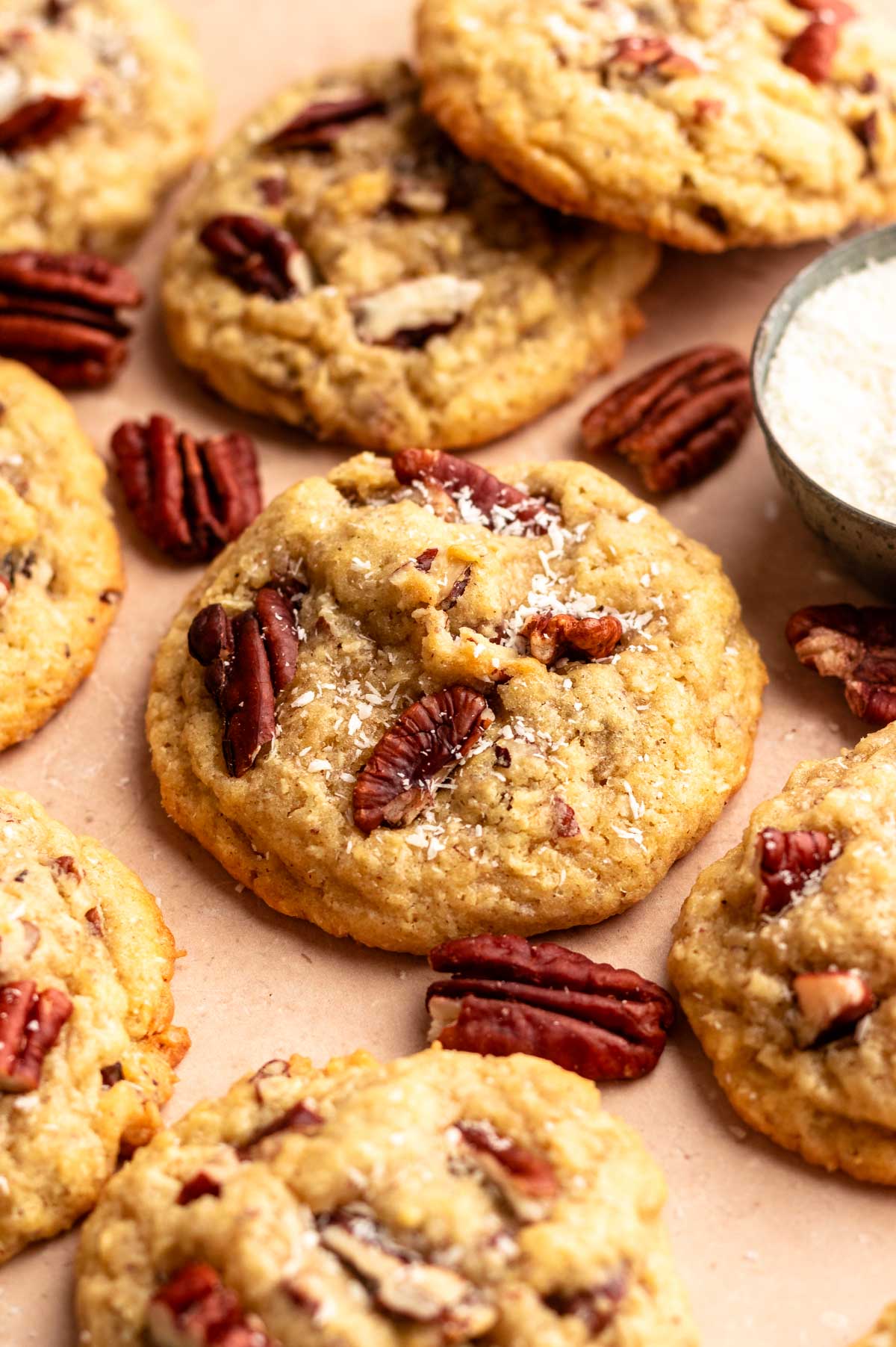 Coconut pecan cookies next to a bowl with coconut.